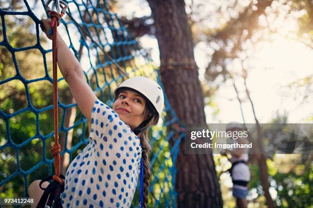 kids having fun during in ropes course  adventure park - assault courses stock pictures, royalty-free photos & images