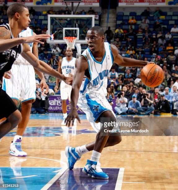 Darren Collison of the New Orleans Hornets keeps the ball away from George Hill of the San Antonio Spurs on March 1, 2010 at the New Orleans Arena in...