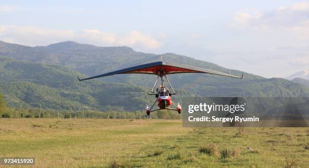 motorized hang-glider takes off - motor paraglider stock pictures, royalty-free photos & images