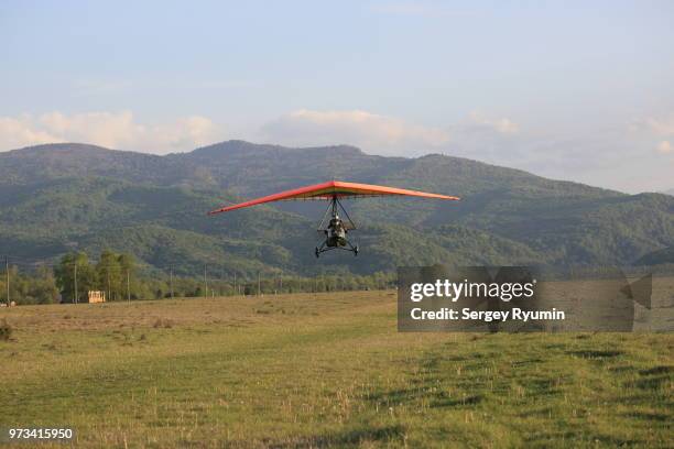 motorized hang-glider takes off - motor paraglider stock pictures, royalty-free photos & images