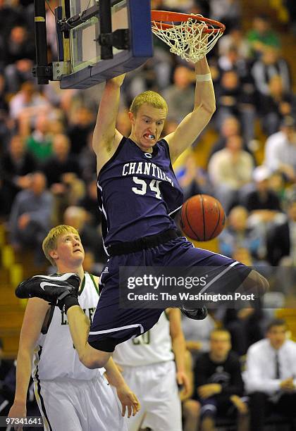 Chantilly's John Manning dunks over Langley's Austin Kriz in the 2nd half as Chantilly defeats Langley 50 - 43 in the Virginia AAA Northern Region...