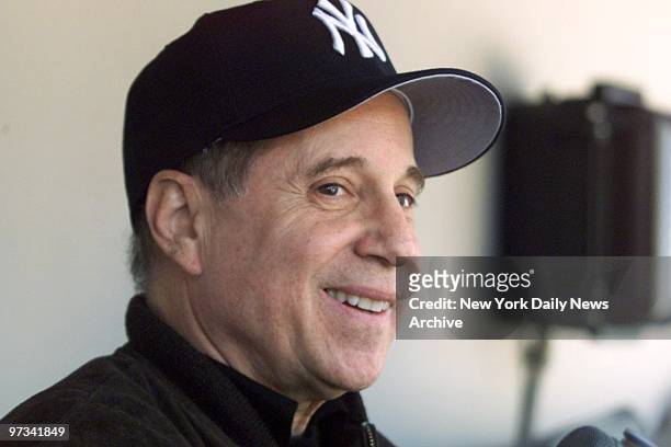 Paul Simon in the New York Yankees' dugout before a memorial ceremony for Joe DiMaggio at Yankee Stadium. Simon sang his song "Mrs. Robinson," which...