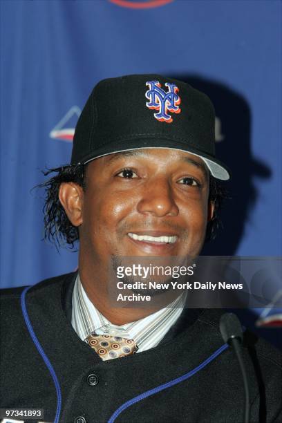 Pedro Martinez is all smiles in his new New York Mets' cap and jersey at Shea Stadium. A $53-million, four-year deal to sign with the Mets may...