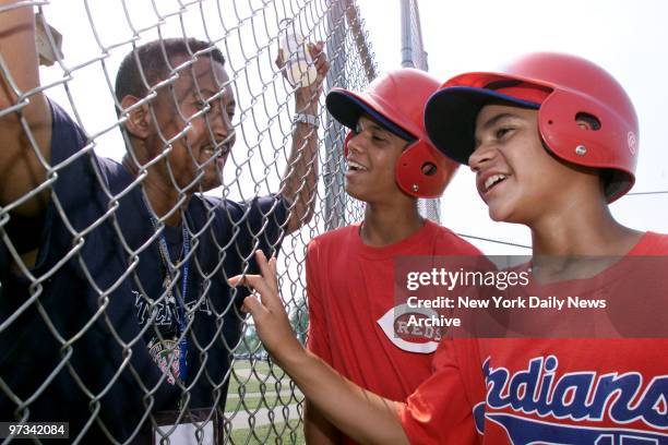 Pedro Espinal chats with ace southpaw Danny Almonte and Luigi Vinas at a Rolando Paulino All-Stars practice session in Williamsport, Pa. Almonte...