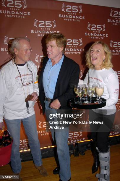 Paul Newman carries a bucket of beer and Glenn Close serves up drinks as they join Robert Redford at the Metropolitan Pavilion to celebrate the 25th...