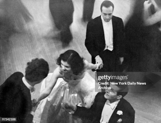 Peter Arno, bottom right and to other admirers vie for a dance with Brenda Frazier at her debut.