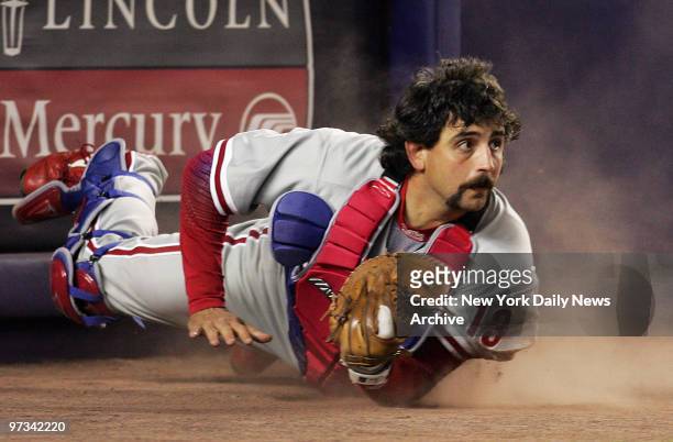 Philadelphia Phillies' catcher Sal Fasano looks up after making a diving catch in the sixth inning of a game against the New York Mets at Shea...