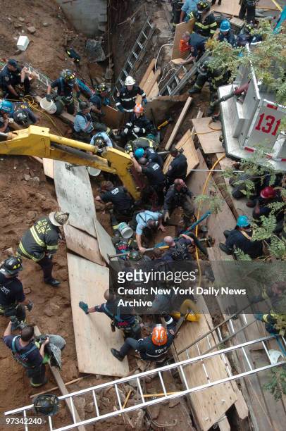 Police and firefighters work to free two construction workers after a wall collapsed at a construction site on 11th St. In Gowanus. Manuel Vergara...