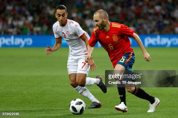 Andres Iniesta of Spain and Saif-Eddine Khaoui of Tunisia battle for the ball during the friendly match between Spain and Tunisia at Krasnodar's...