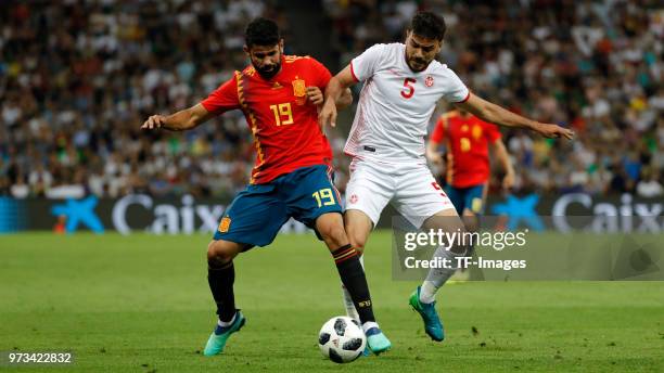 Diego Costa of Spain and Oussama Haddadi of Tunisia battle for the ball during the friendly match between Spain and Tunisia at Krasnodar's stadium on...