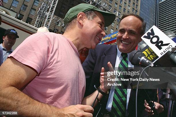 Paul Simon talks with Mayor Rudy Giuliani on Broadway.