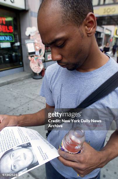 Pedestrian in Chelsea looks at flyer announcing the search for British murder suspect Richard Markham. Markham was later apprehended and confessed to...