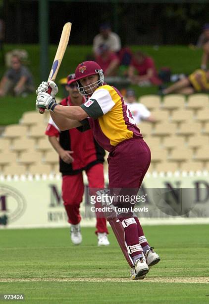 Clinton Perren of Queensland cuts Mark Harrity to the boundary in the Mercantile Mutual Cup match between the South Australian Redbacks and the...