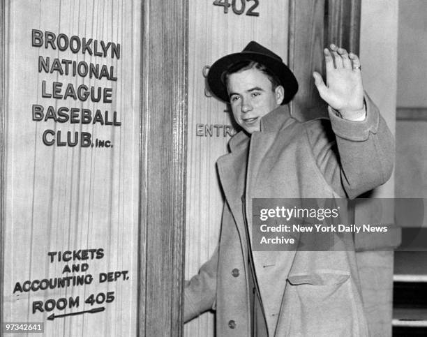 Pee Wee Reese, Dodgers' shortstop, waves as he stops at Dodgers' baseball office at 215 Montague St. For an X-Ray of his ankle.