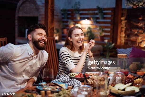 friends dining outdoor - group of people eating dinner stock pictures, royalty-free photos & images