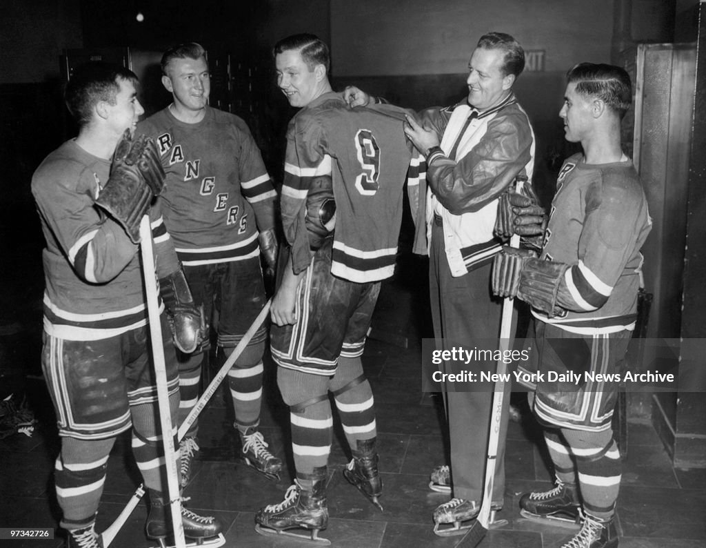 Pentti Lund (center), who now wears No. 9, gets measured for
