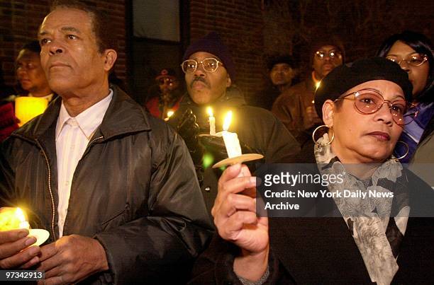 People hold candles at vigil outside the apartment building on Wheeler Ave. In the Bronx, where Amadou Diallo lived - and died in a hail of 41 police...