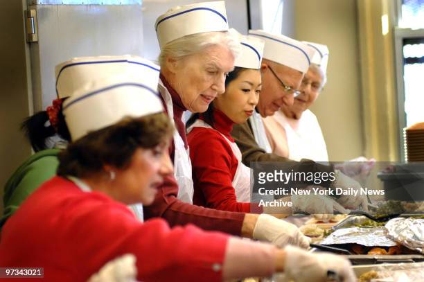 People prepare and are served holiday dinner at the Holy Apostle church on 9th Ave on Monday.