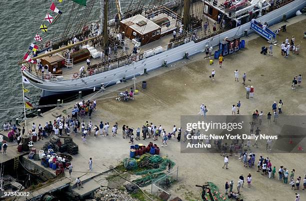 People wait in line to board the ship Cisne Branco from Brazil. The ship will head to New York for the beginning of OpSail 2000.