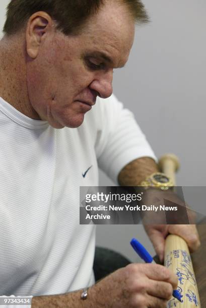 Pete Rose autographs a baseball bat at One if by Cards, Two if by Comics, a sports memorabilia store in Scarsdale, N.Y.