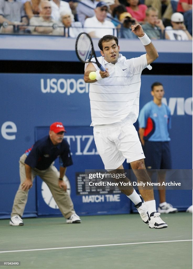 Pete Sampras goes airborne as he hits a return to Andre Agas