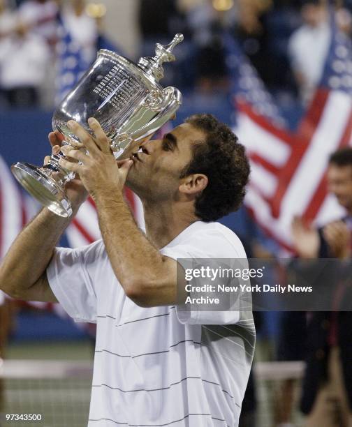 Pete Sampras kisses the men's singles championship trophy after winning his U.S. Open finals match against Andre Agassi at Arthur Ashe Stadium in...