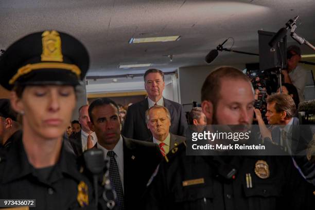 James Wolfe former director of security with the Senate Intelligence Committee escorts former FBI Director James Comey out of the hearing room in the...