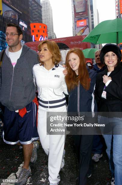 Peter Hermann, wife Mariska Hargitay, Julianne Moore and Lilly Tartikoff make their way through Times Square this morning during the eighth annual...