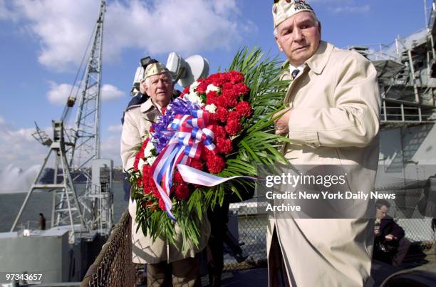 Peter Sarantopoulas of Bardonia, N.Y., and Joseph Medure of the Bronx prepare to drop wreath into the Hudson River during the annual Pearl Harbor Day...