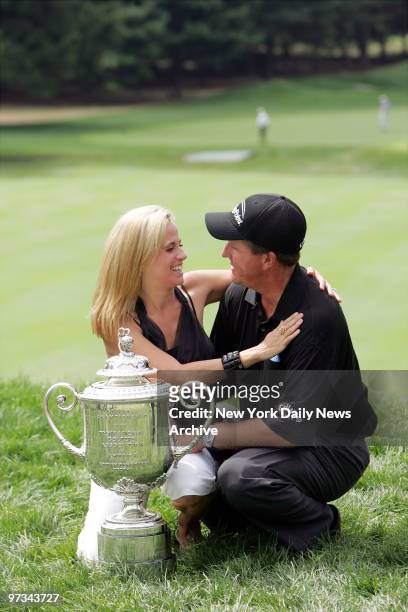 Phil Mickelson celebrates with his wife, Amy, next to the Wanamaker Trophy after he won the 87th PGA Championship at Baltusrol Golf Club in...