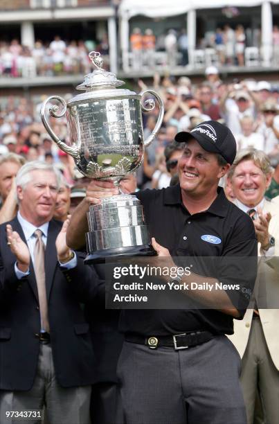 Phil Mickelson holds up the Wanamaker Trophy after winning the 87th PGA Championship at Baltusrol Golf Club in Springfield, N.J.