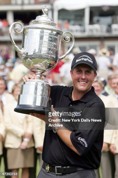Phil Mickelson holds up the Wanamaker Trophy after winning the 87th PGA Championship at Baltusrol Golf Club in Springfield, N.J.