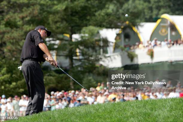 Phil Mickelson makes a chip shot from the deep rough around the 18th green that led to the winning putt at the 87th PGA Championship at Baltusrol...