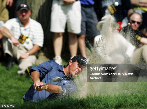 Phil Mickelson of the U.S. Shoots out of a bunker on No. 6 during the third day of the U.S. Open golf championship at Winged Foot Golf Club in...