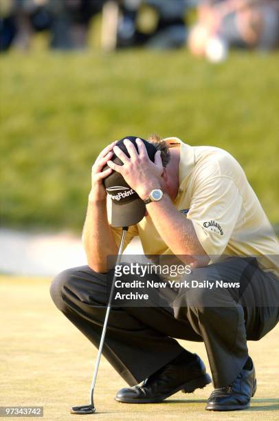 Phil Mickelson of the United States holds his head as he loses the lead at the 18th hole during the final round of the 2006 U.S. Open Championship at...
