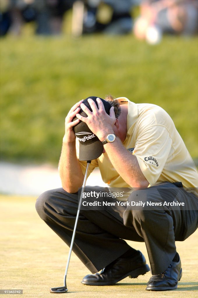 Phil Mickelson of the United States holds his head as he los