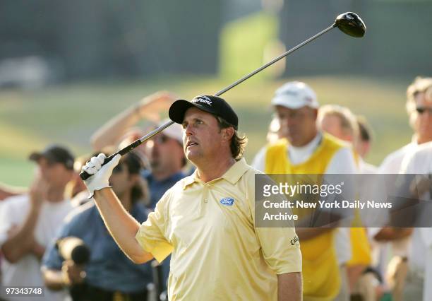 Phil Mickelson of the United States watches as his ball heads for the trees after teeing off to start the 18th hole during the final round of the...