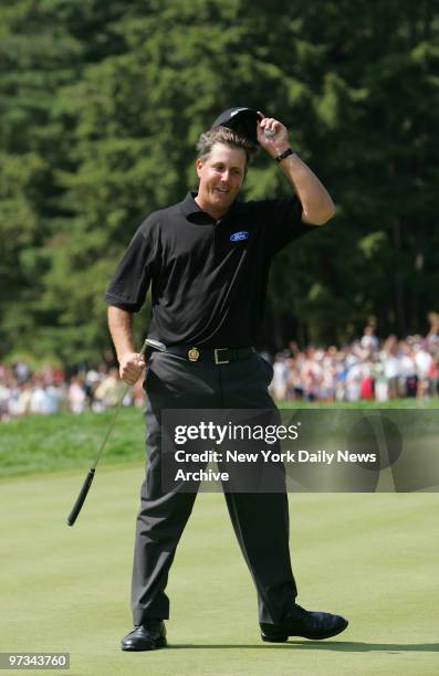 Phil Mickelson tips his cap to fans after sinking the winning putt at the 87th PGA Championship at Baltusrol Golf Club in Springfield, N.J.