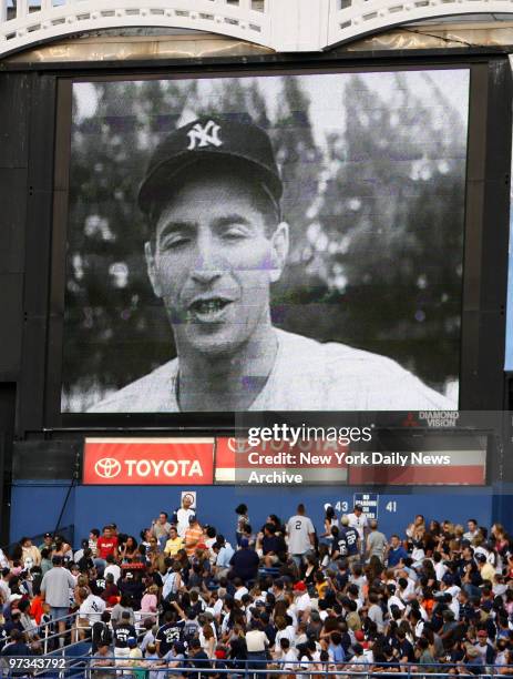 Phil Rizzuto's image is displayed on a screen at Yankee Stadium during a tribute to the New York Yankees legend, who died today at age 89. The...