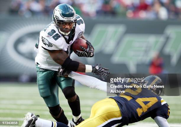 Philadelphia Eagles' running back Brian Westbrook breaks the tackle of New York Jets' cornerback Darrelle Revis in the first half of a game at Giants...