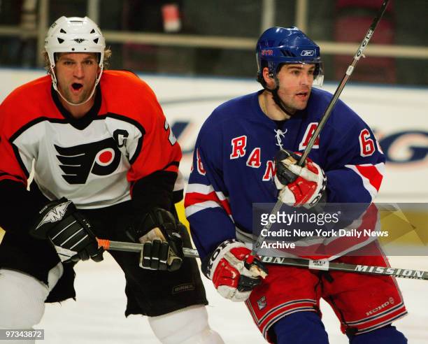 Philadelphia Flyers' Derian Hatcher and New York Rangers' Jaromir Jagr chase the puck. Despite a Jagr hat trick, the Rangers lost, 6-3, at Madison...