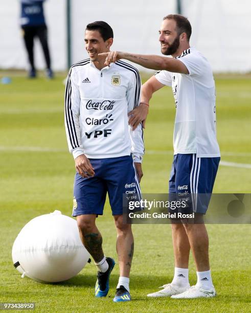 Gonzalo Higuain of Argentina and Angel Di Maria of Argentina laugh during an open to public training session at Bronnitsy Training Camp on June 11,...