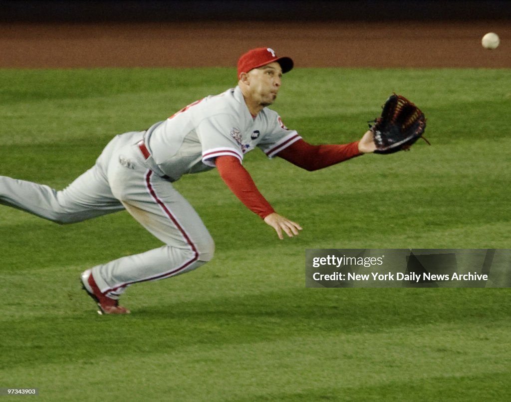 Philadelphia Phillies' Raul Ibanez catches hit by New York Y