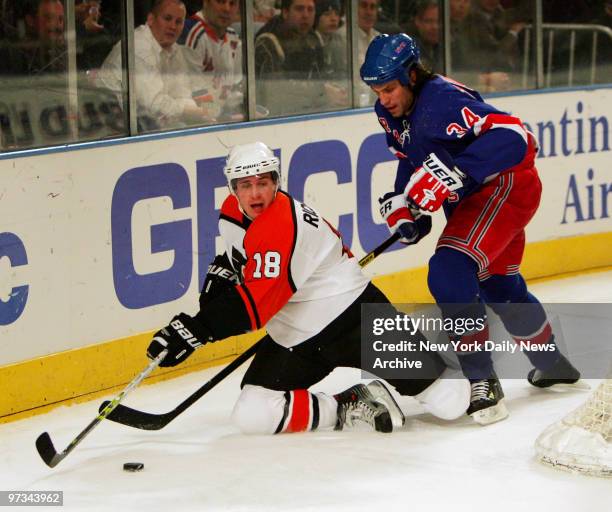 Philidelphia Flyers' Mike Richards hits the ice as he's chased by New York Rangers' Jason Strudwick. Despite a Jaromir Jagr hat trick, the Rangers...