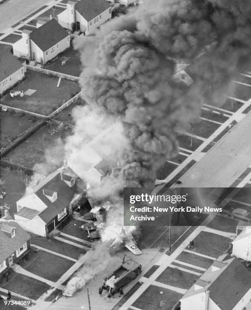 Photograph of B-26 bomber which crashed into a home, 61 Barbara Drive in East Meadow, Long Island, causing the house to catch fire. Both airmen from...