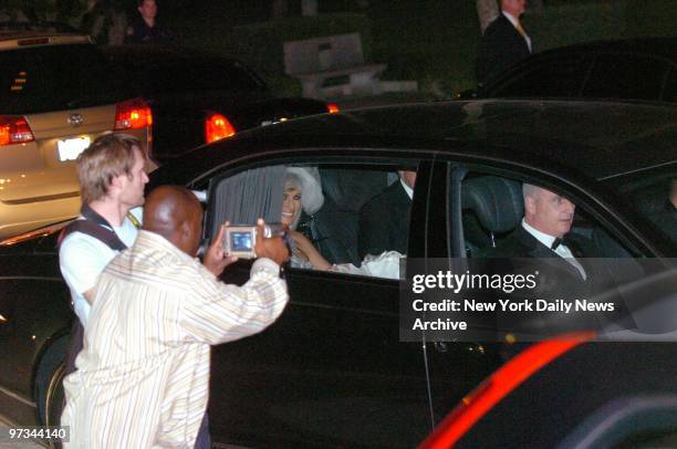 Photographers snap pictures as a beaming Melania Knauss and new husband Donald Trump leave the Episcopal Church of Bethesda-by-the-Sea in Palm Beach,...