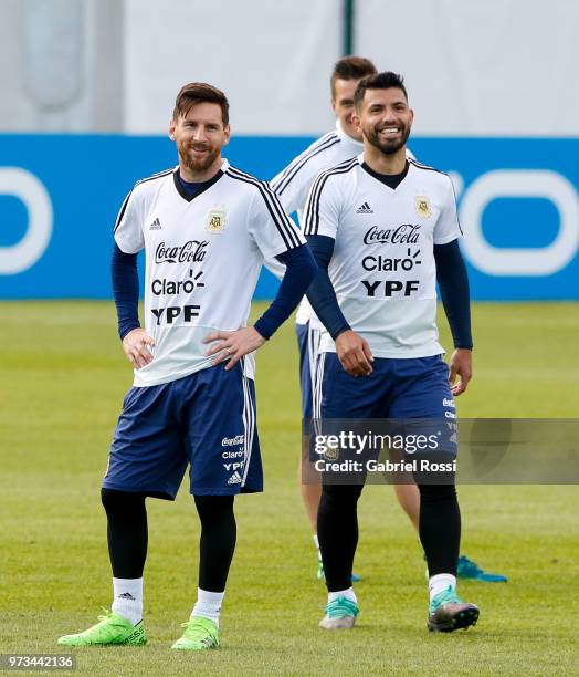 Lionel Messi of Argentina and Sergio Aguero of Argentina laugh during an open to public training session at Bronnitsy Training Camp on June 11, 2018...