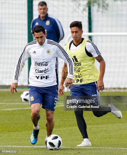 Angel Di Maria of Argentina fights for the ball with Maximiliano Meza of Argentina during an open to public training session at Bronnitsy Training...