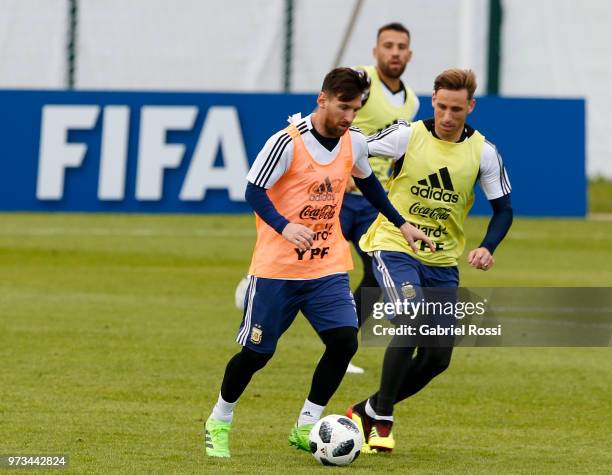 Lionel Messi of Argentina fights for the ball with Lucas Biglia of Argentina during an open to public training session at Bronnitsy Training Camp on...