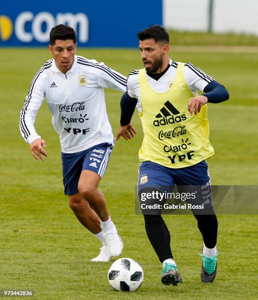 Sergio Aguero of Argentina fights for the ball with Enzo Perez of Argentina during an open to public training session at Bronnitsy Training Camp on...